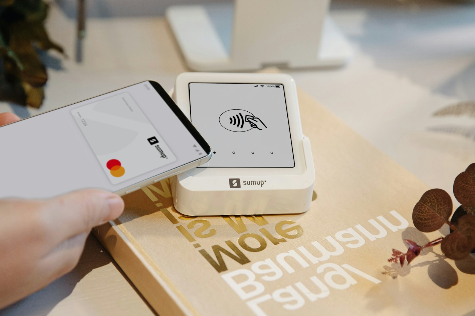 A phone making a contactless payment on a card reader